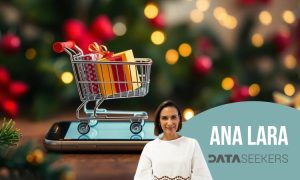 Image de un carrito de compras digital sobre la pantalla de un móvil, en un ambiente navideño.