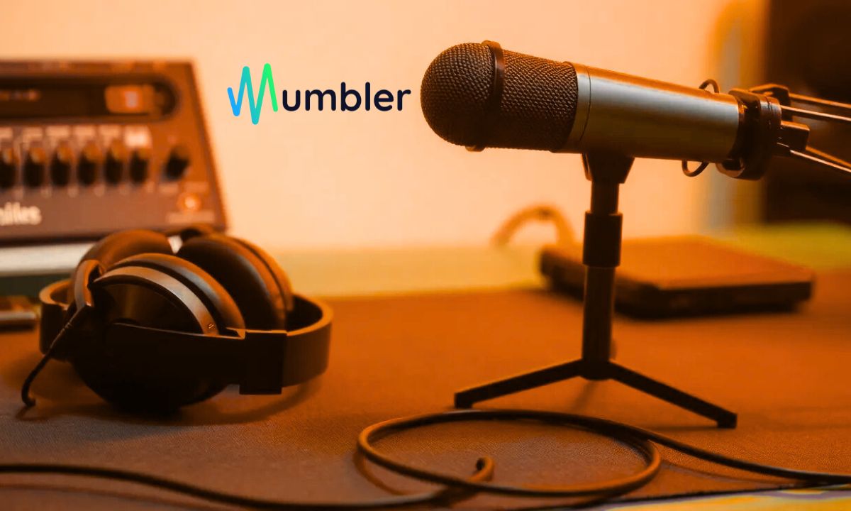 headphones on a table, near a professional microphone, mumbler logo