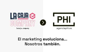 La imagen muestra una comparación entre dos logotipos. A la izquierda, está el de "LA CAJA COMPANY" con un diseño colorido en tonos rosados y azules, seguido de su URL "lacaja.company". A la derecha, está el logotipo de "PHI" con un diseño minimalista y elegante en color negro, seguido de la URL "agenciaphi.es". En la parte inferior de la imagen, se lee el texto: "El marketing evoluciona... Nosotros también."