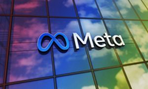 Fotografía de la fachada de un edifcio acristalado en el que se proyectan nubes y una luz arcoíris. En la fachada se ve un cartel con el logotipo de Meta.